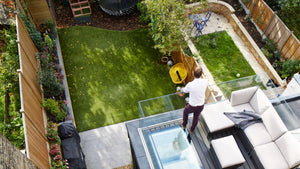 Man standing at the edge of a walk on rooflight overlooking a green garden