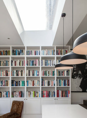 flat rooflight installed above a full, white book case 