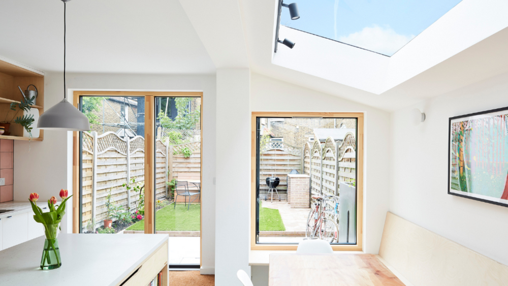 roof window installed in the roof of a light and white modern kitchen