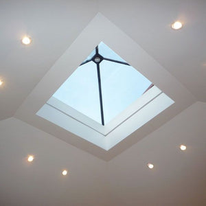 Pyramid rooflight viewed from below in a room with white paint and spotlights