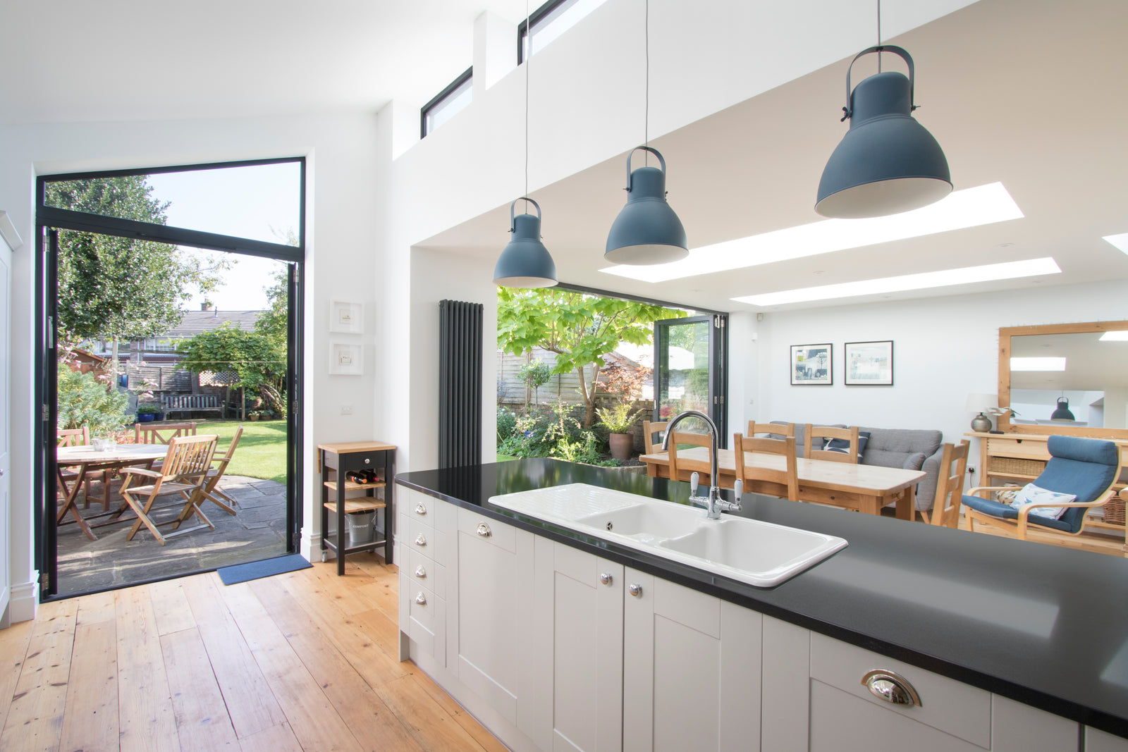 flat rooflights installed in a modern kitchen with a grey countertop and doors leading to the garden