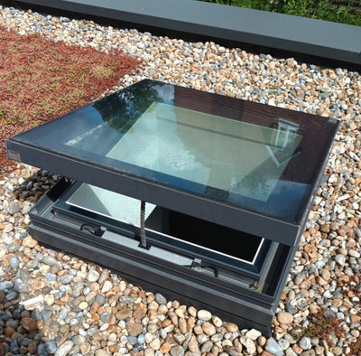 open rooflight on a rooftop surrounded by stone and green and red foliage