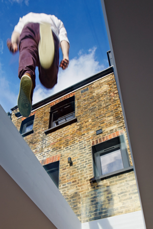 man walking on a walk-on rooflight viewed from below